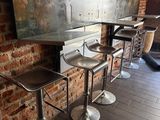 three stools that are sitting in front of a brick wall
