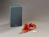 a piece of gummy sitting on the ground next to a box