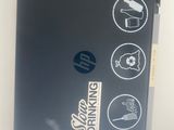 a laptop with stickers on it sitting on a table