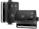 two black speakers are sitting next to each other on a white surface