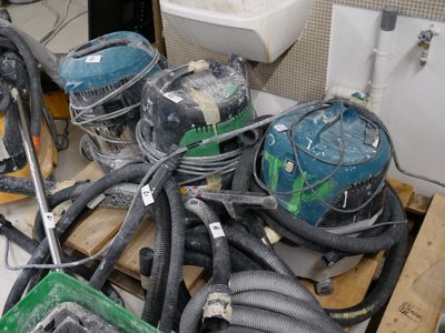 a pile of vacuums and other equipment on a pallet