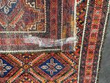 a close up of a rug on the ground with a piece of plastic covering it