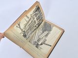 a person holding an open book with a drawing on it