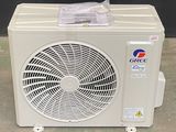 a small air conditioner sitting on the floor in front of a black wall