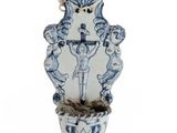 a blue and white vase with a bird on it