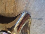 a close up view of a shiny faucet on a wooden floor