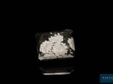 a close up of a piece of rock on a black surface
