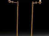 a pair of brass plated floor lamps