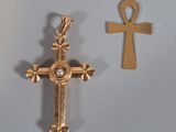 an image of a cross and an ankht on a white surface