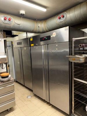stainless steel refrigerators in a commercial kitchen with a lot of counter space
