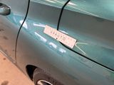 a blue car with a sticker on the side of it ' s door