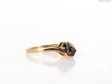 an image of a gold ring with a sapphire stone