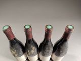 three bottles of wine are lined up on a table