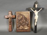 a statue of jesus on the cross next to a crucifix