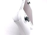a close up of a video game controller on a white surface