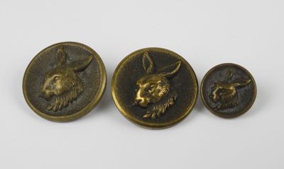 three antique brass buttons with a rabbit and rabbit head on them