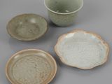three bowls and a bowl sitting on top of a table