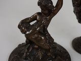 two bronze figurines of a man and a woman