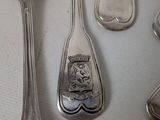 many spoons and spoon spoons sitting on a table