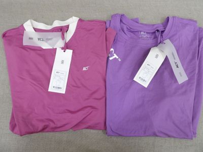 two purple and pink shirts with white tags on them sitting next to each other