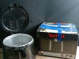 a box of food sitting next to an air fryer on a table