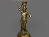 une image représentant une statue de femme tenant un bol posé sur une table