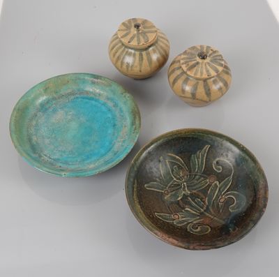 three bowls and a bowl sitting on a table