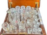 many glasses in a wooden box on a table