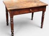 an old wooden table with a drawer on top of it