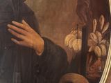 portrait of a man with a skull in a gold frame