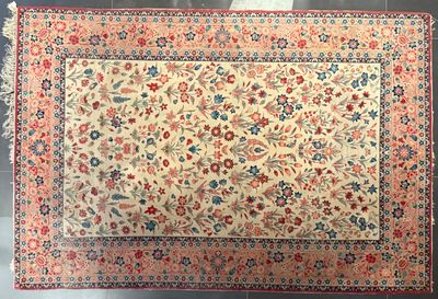 an antique persian rug with floral design and fringes