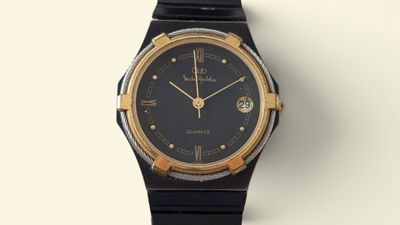 a black and gold watch on a white surface