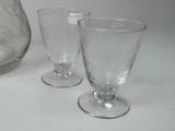 two glasses and a vase on the table