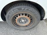 a white car with a flat tire on the street