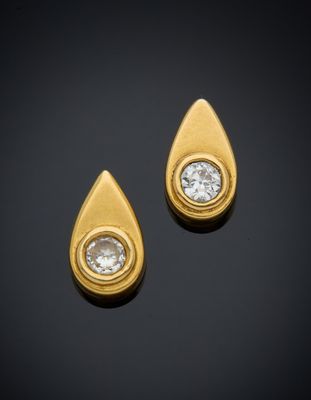 a pair of gold and diamond earrings