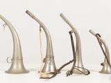 several different types of musical instruments are lined up on a white surface