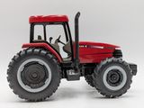 a red tractor that is sitting on a white surface