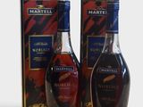 two bottles of brandy and a box of wine on a white surface