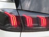 a close up of a car tail light with red lights