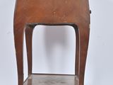 an old wooden side table with a drawer on top of it