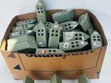 a cardboard box filled with lots of small green houses