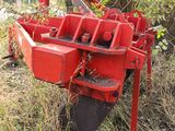a red machine that is sitting in the grass