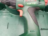 a cordless drill that is sitting in a green box
