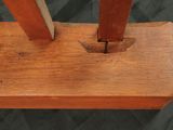 a close up of a wooden object on a black background