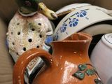 a brown vase with a duck on top of it in a box