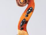 a close up of a violin ' s bow with a spiral design on it