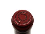 a close up of a bottle of wine on a white surface
