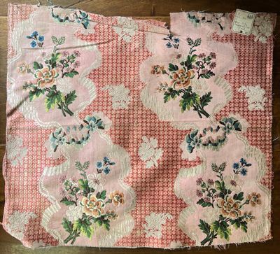 a piece of pink fabric with flowers on it on a table