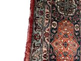 an image of a long rug with a red border and a blue background