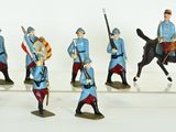 many figurines of men in uniforms riding horses